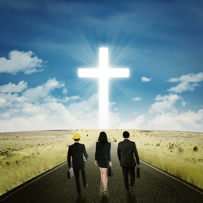 business people walking toward cross